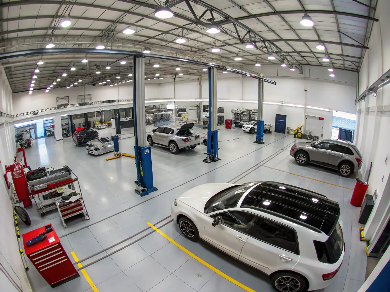 A modern, well-equipped auto body shop with state-of-the-art tools and equipment, showcasing Sontay Body Shop & Paint's commitment to using the latest technology.